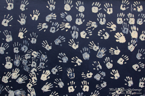 Handprints on a black wall