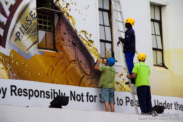 How many men does it take to put up a sign?