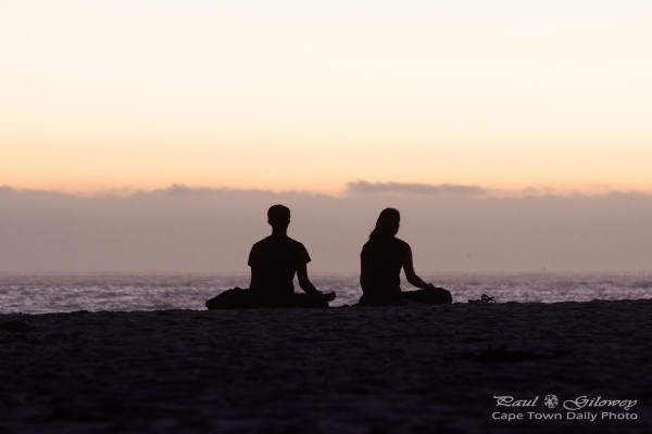 Meditating on Camps Bay beach's sunset